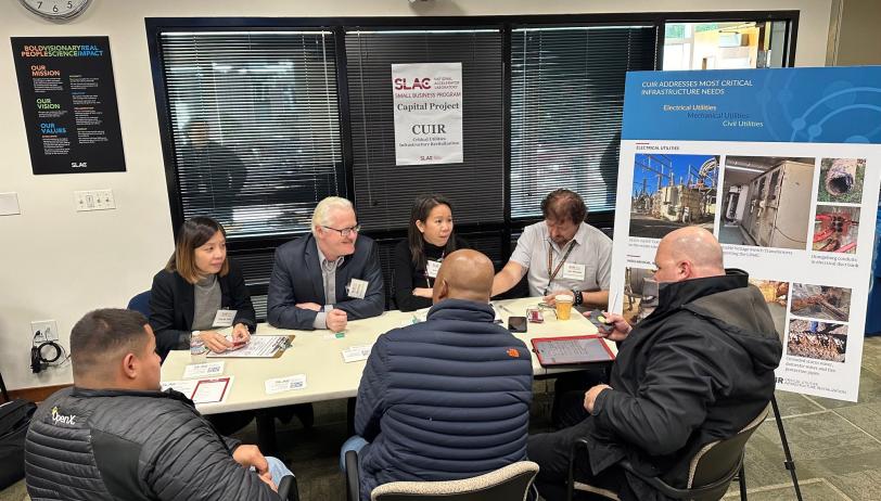 small group of attendees sitting around table discussing opportunities